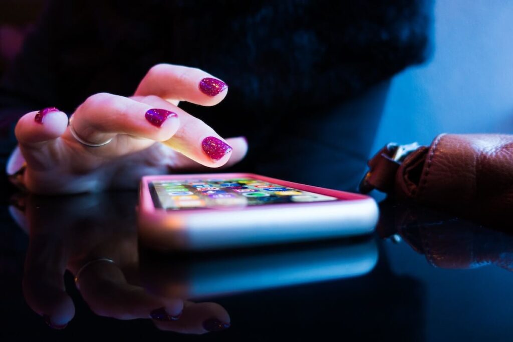 woman about to tap on phone screen
