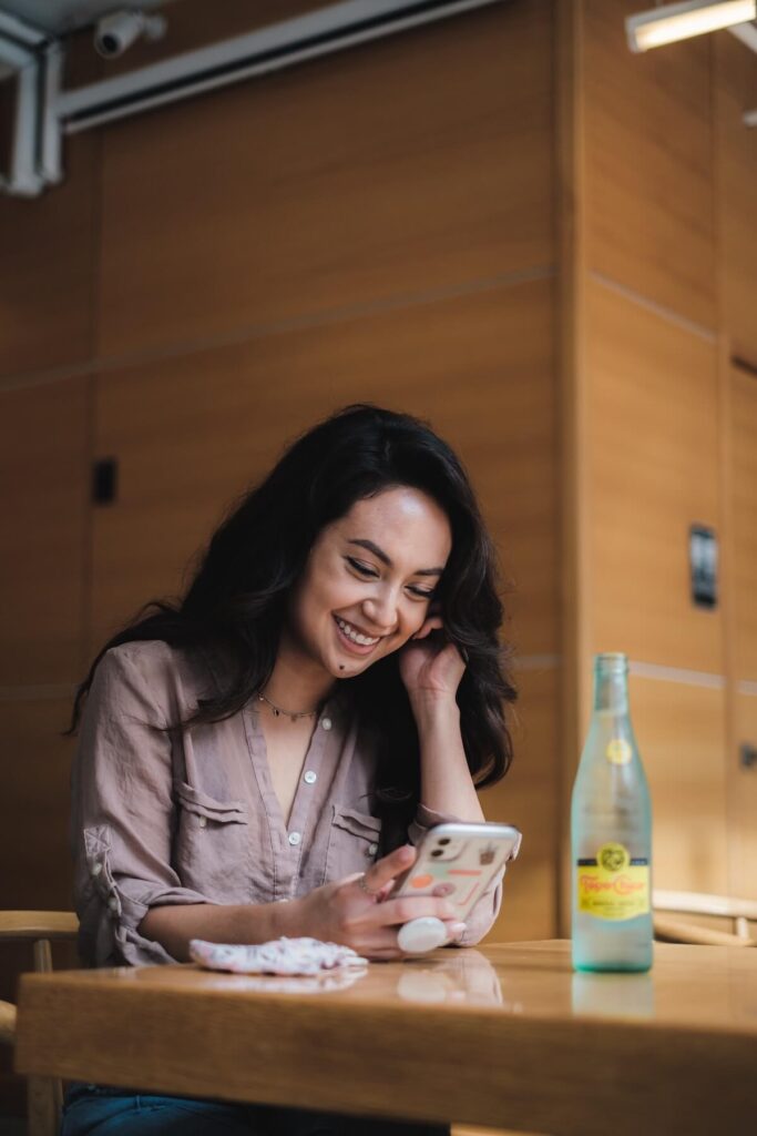 woman smiling at phone