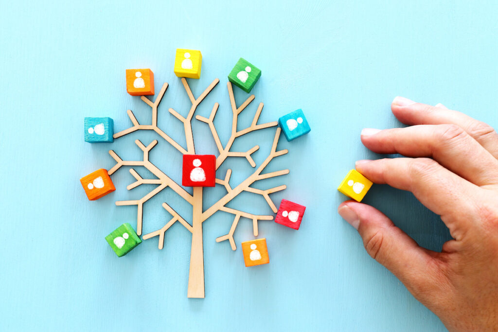 image of wooden tree with people icons over blue table
