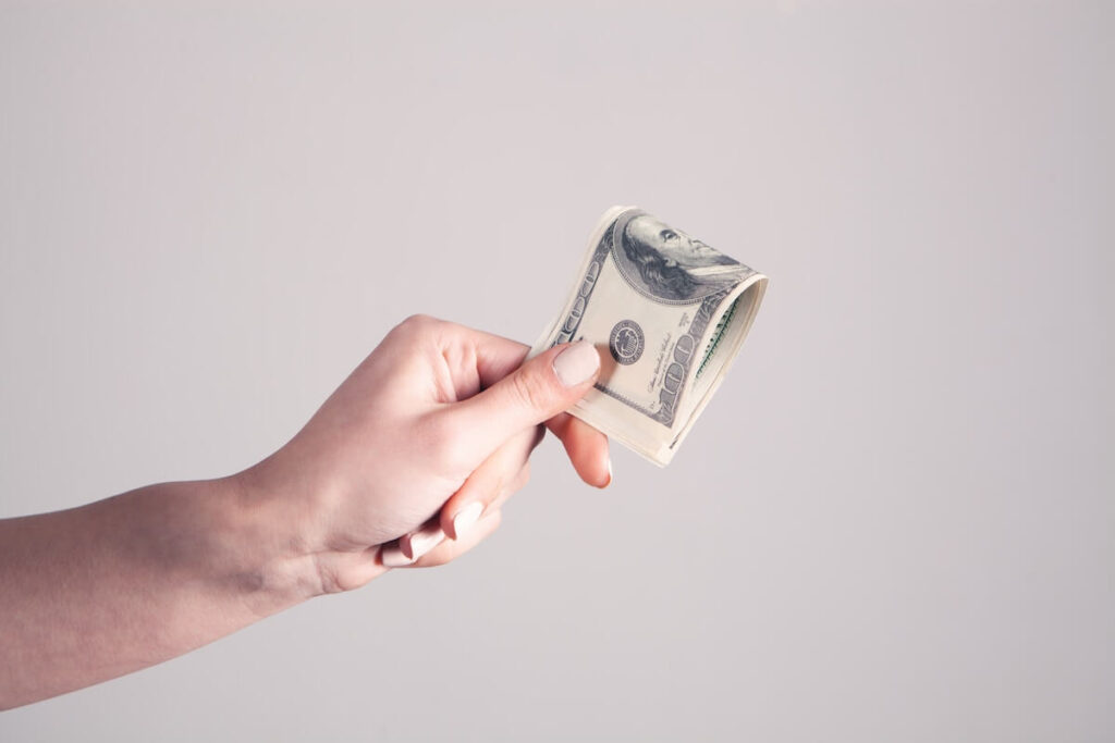 person holding bunch of 100-dollar bills
