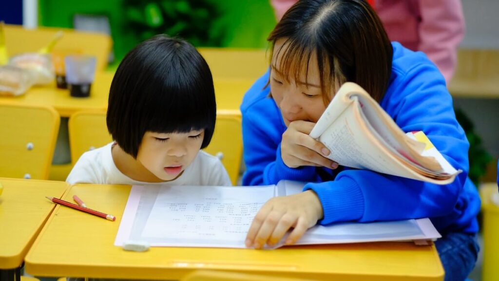 woman tutors little girl