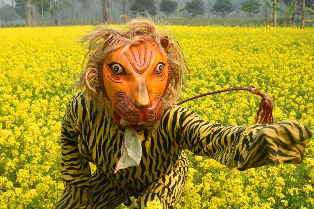 person wearing a wooden tiger mask