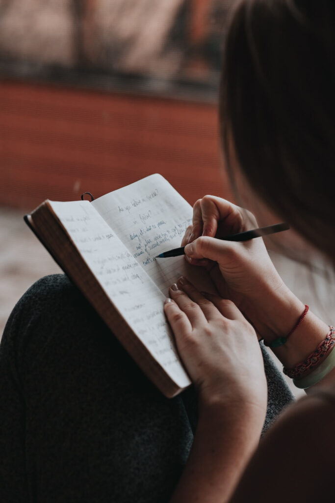 woman writing on personal journal