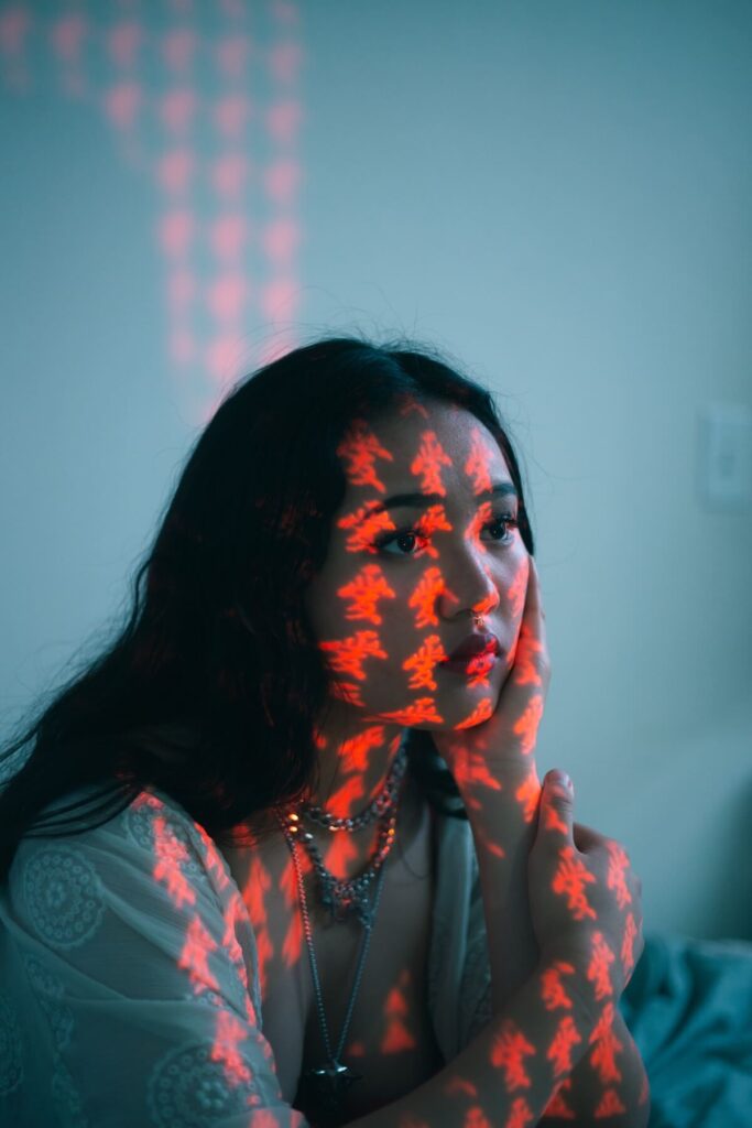 woman with Chinese texts reflected on her body and face