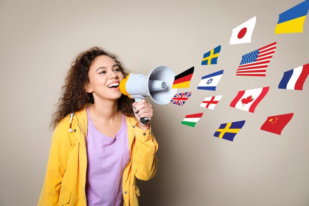multiple country flags come out of megaphone as young woman speaks