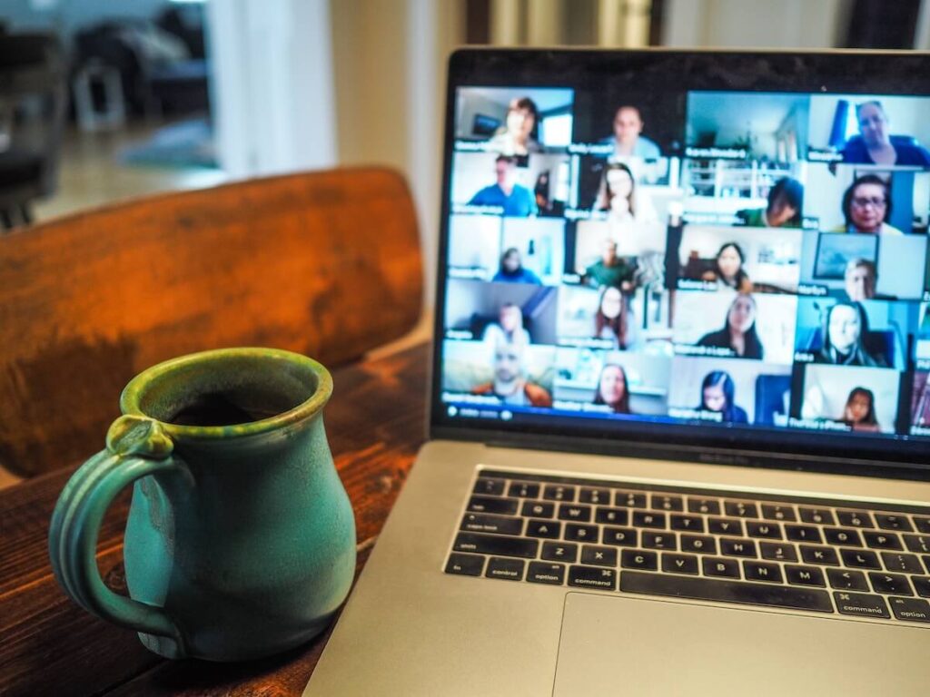 group chat on computer screen beside mug