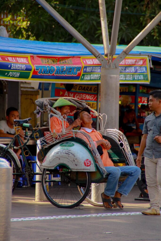 old men riding rickshaw in Yogyakarta