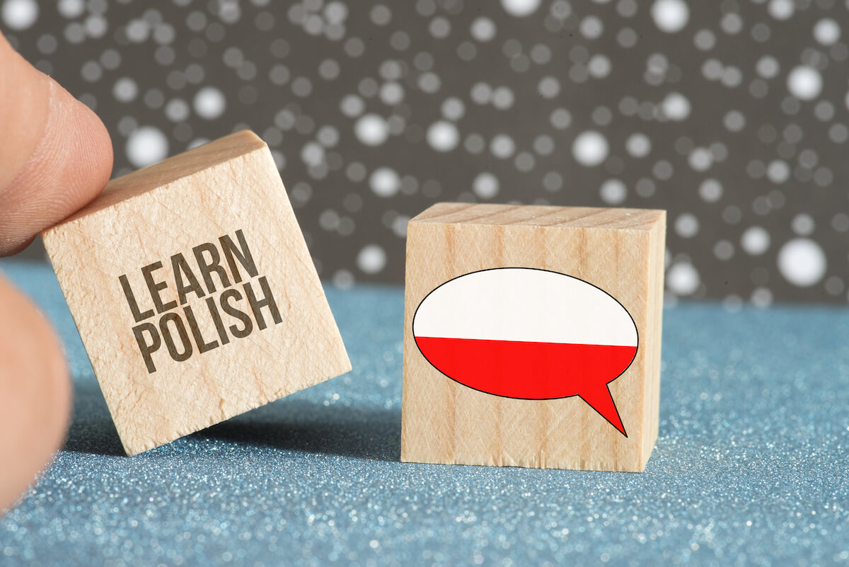 wooden cubes with Polish flag and “learn Polish”