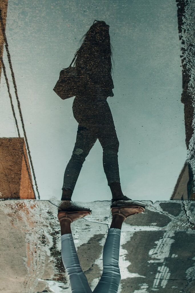 trippy composition of woman walking past reflection