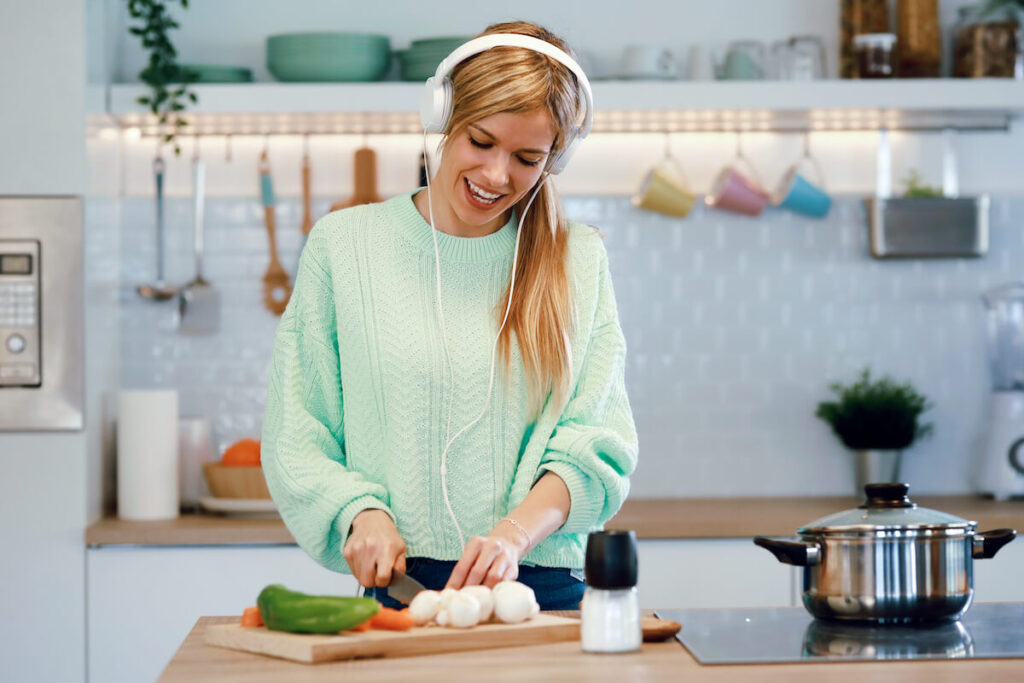 woman cooking with headphones on