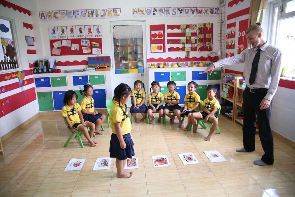 Student stands on flashcard in classroom