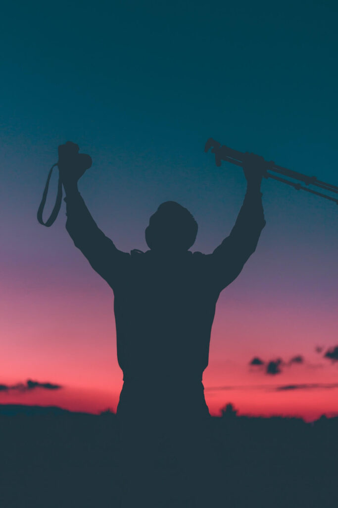 man celebrating achievement blue hour
