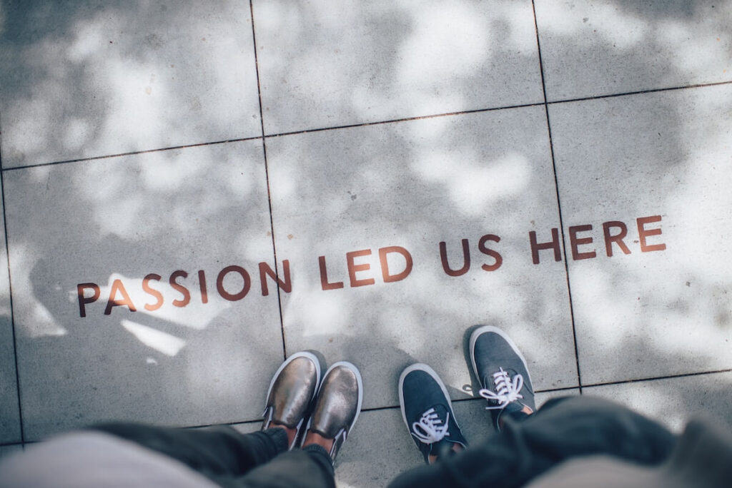 two people standing by passion led us here inscription on floor