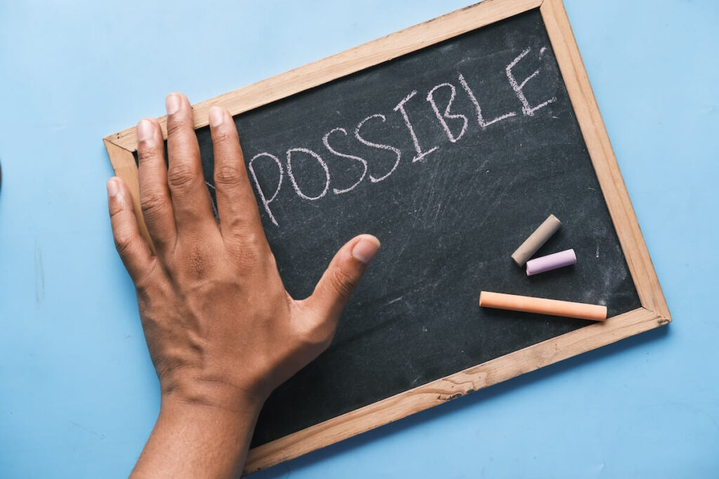 person hiding impossible prefix on blackboard