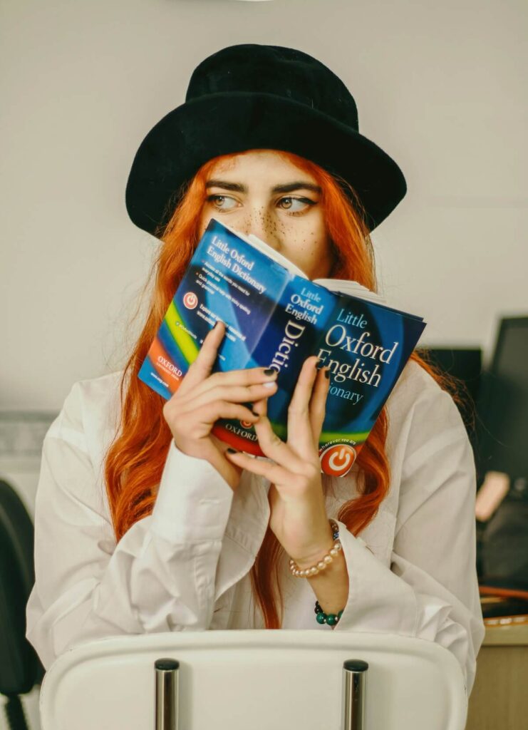 woman holding an Oxford English Dictionary