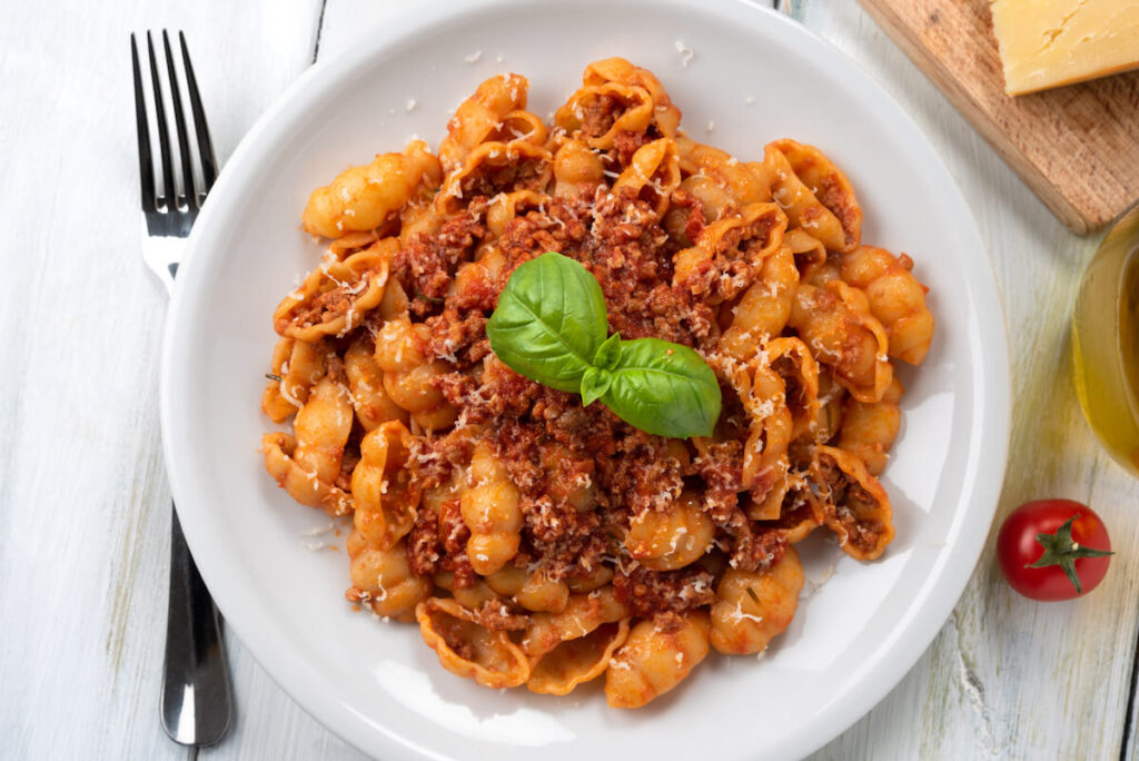Dish of italian gnocchi pasta with bolognese ragu sauce