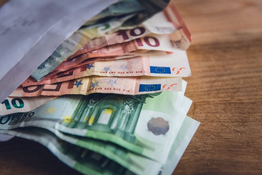 euro banknotes peeking out from envelope