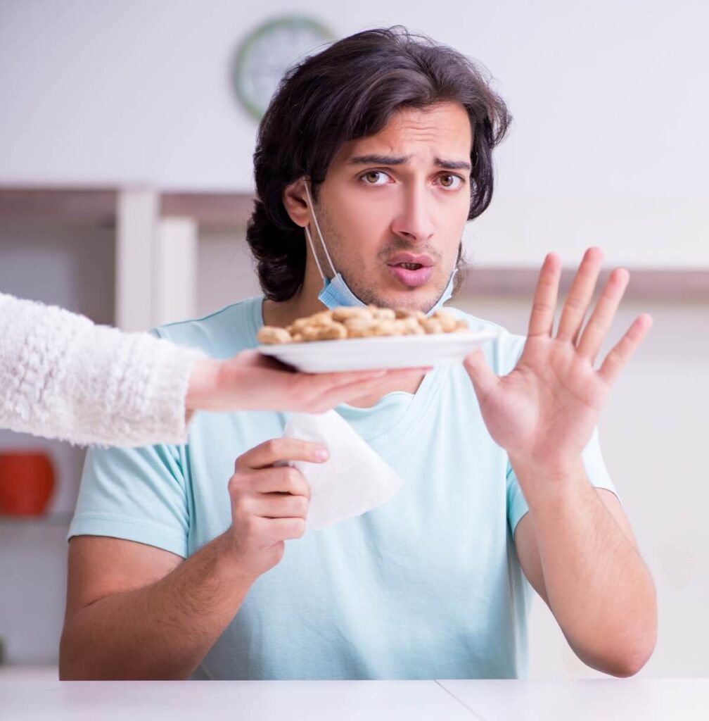 young man suffering from food allergy