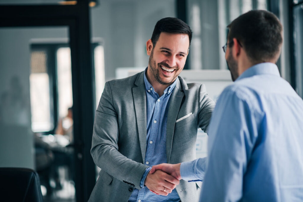 cheerful manager handshake with an employee