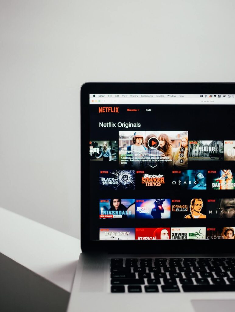 laptop showing Netflix shows