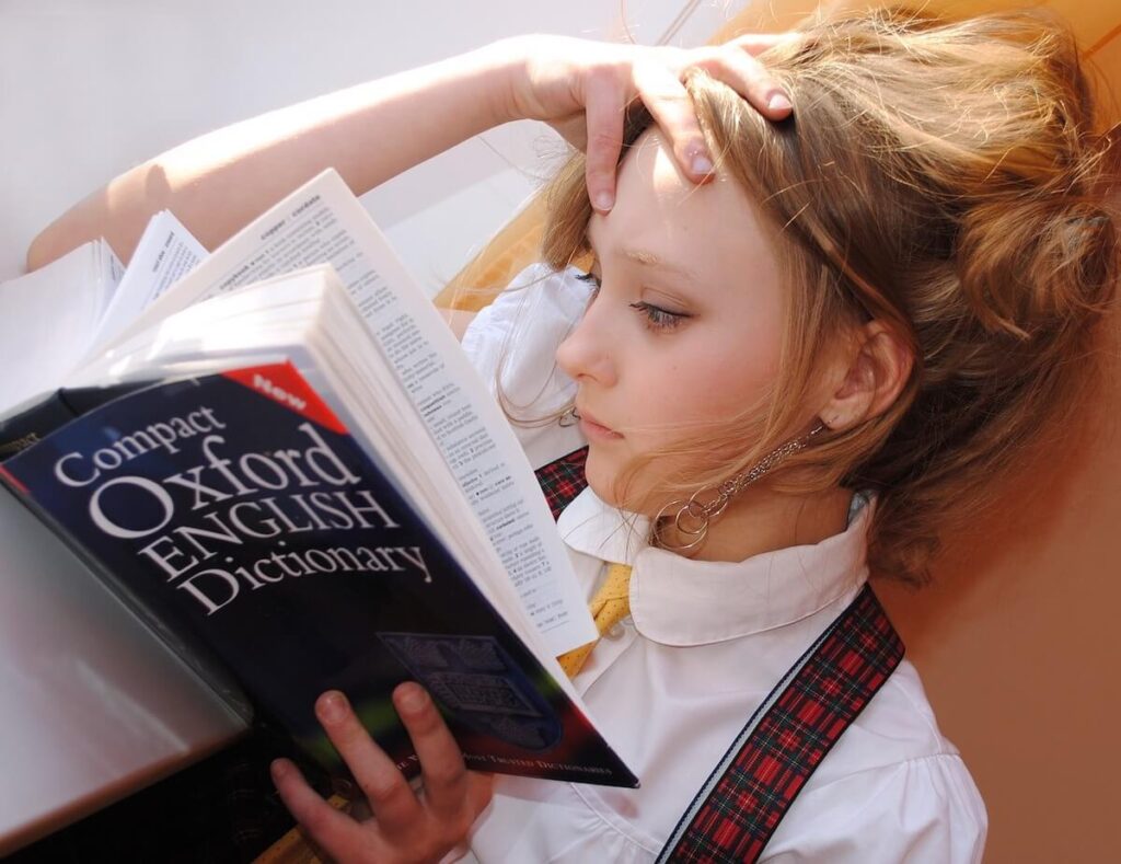woman reading Oxford English dictionary