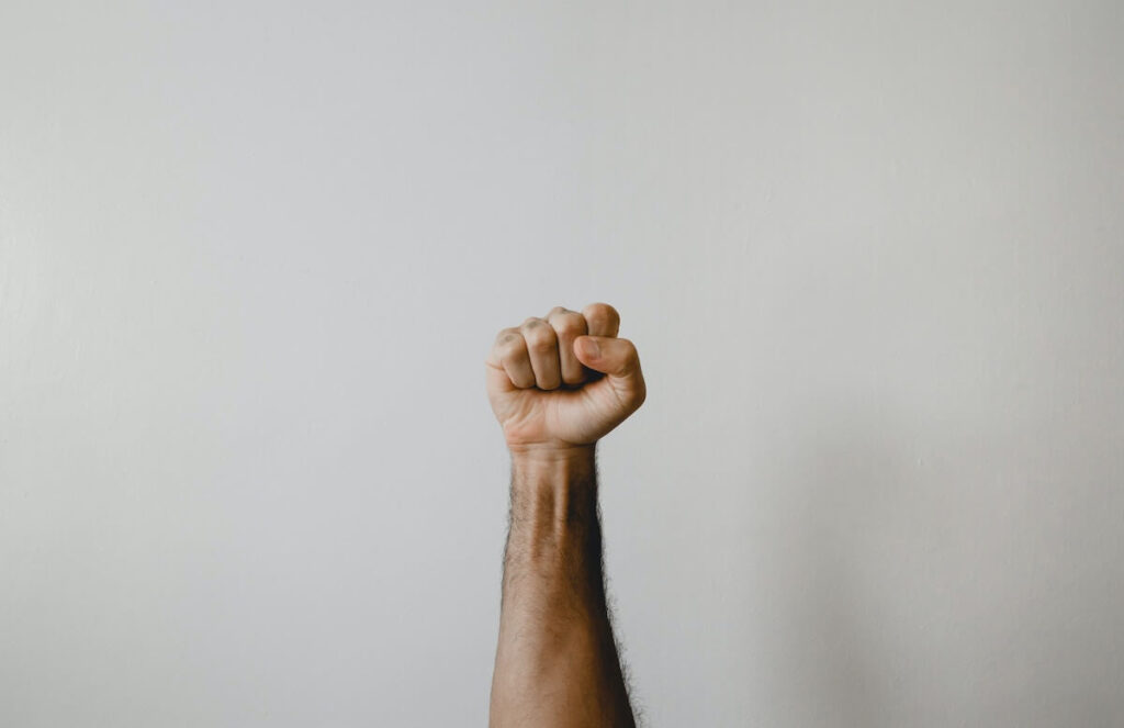 focus on raised arm and fist
