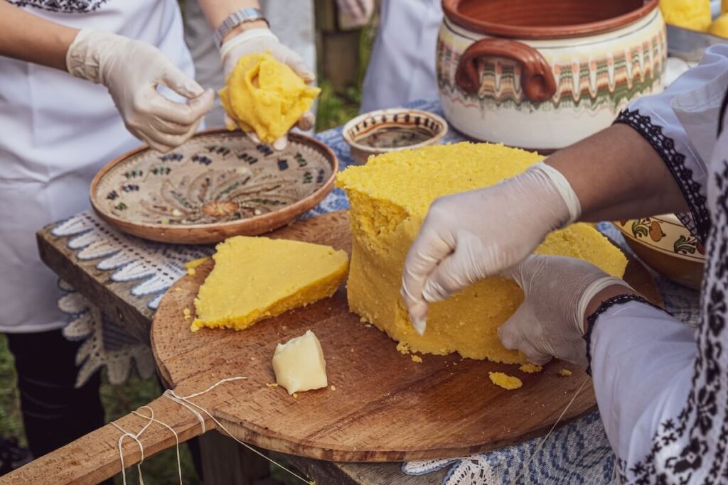 two people slicing polenta
