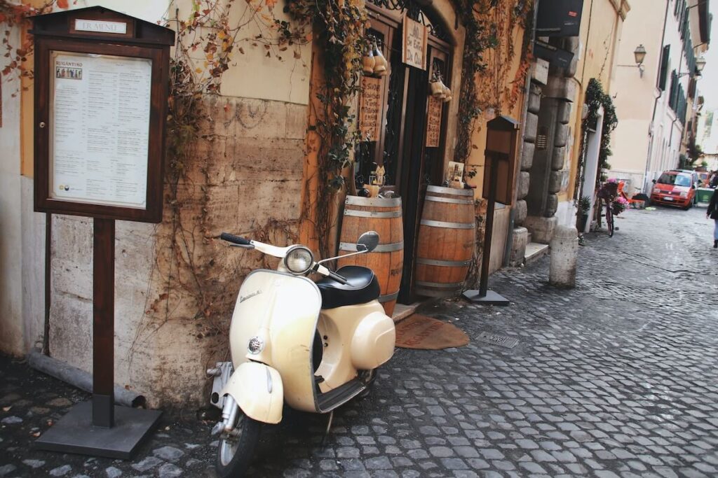 vespa parked outside italian restaurant