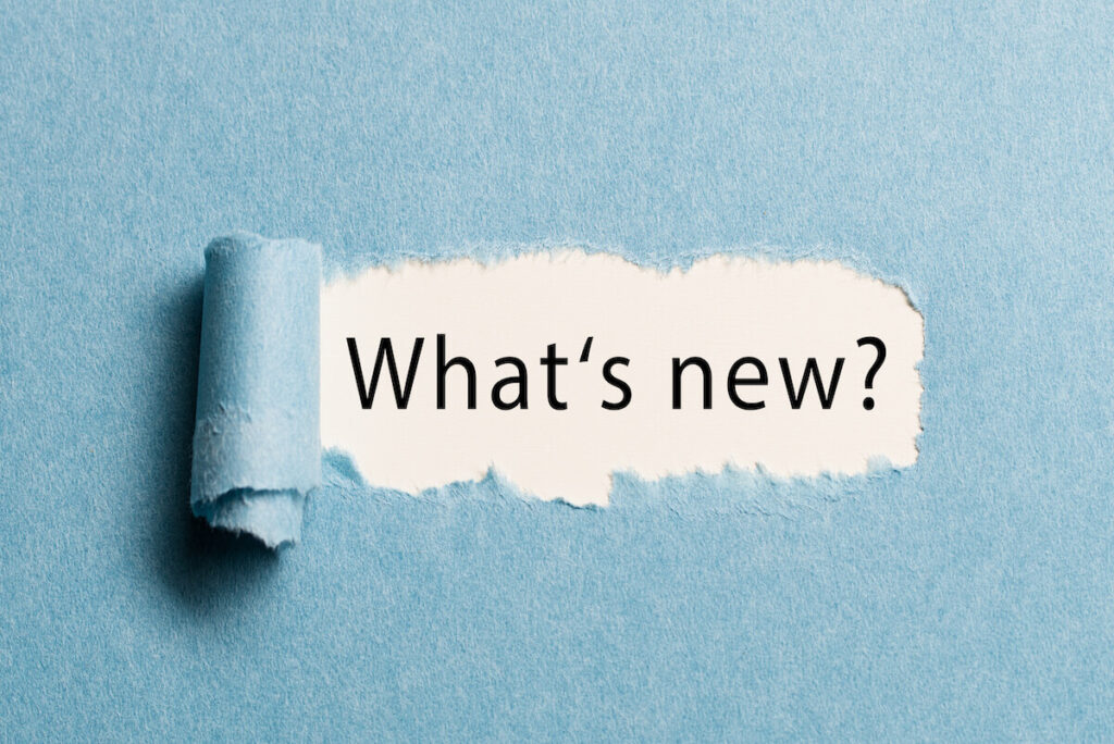 torn paper revealing the phrase "what's new?"