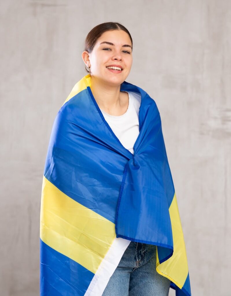 woman covered in Swedish flag
