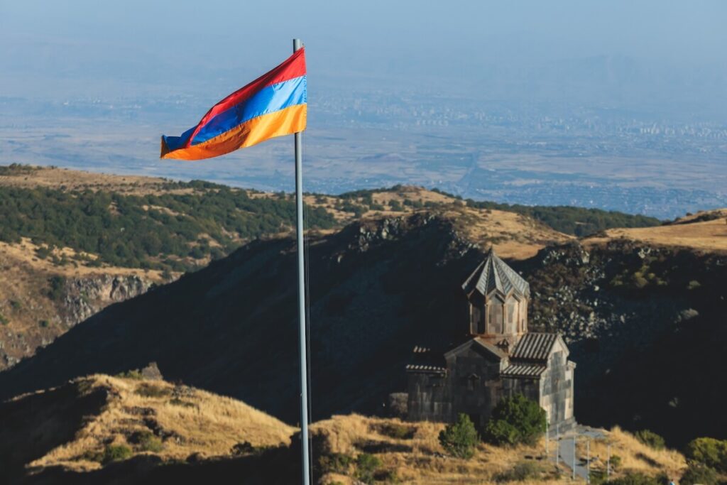 View of waving flag of Armenia with mountain landscape in the background