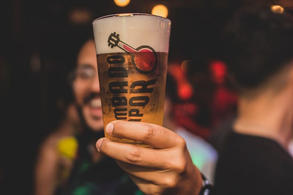 man holding glass of beer