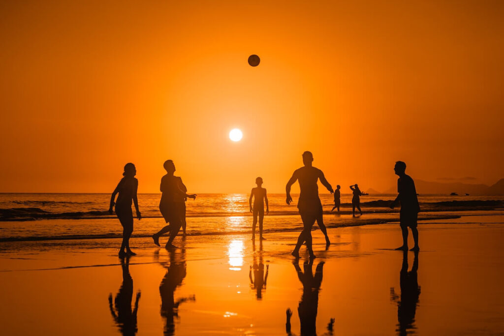 group playing altinha on beach