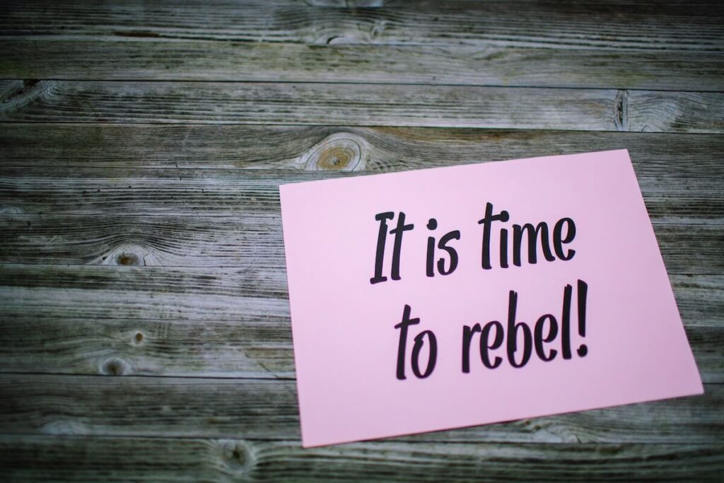 “it is time to rebel” written on card