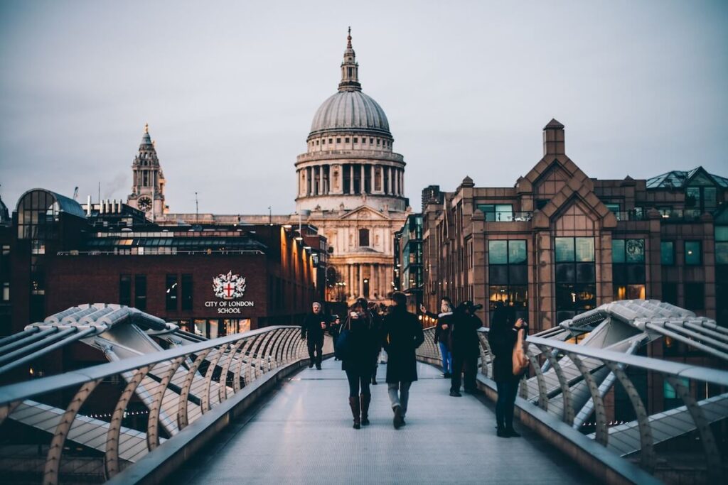 people crossing Millennium Bridge toward St. Pauls