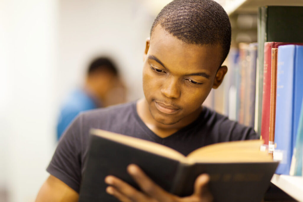 man reading a book in library