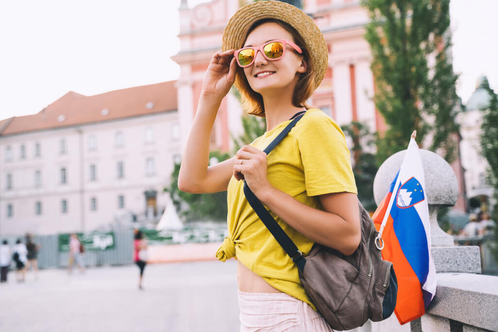 woman in Slovenia with Slovenian flag in backpack