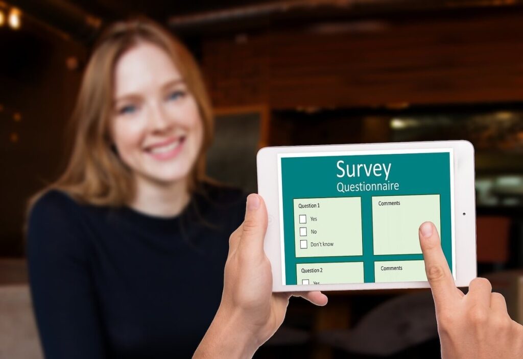 Survey on phone with smiling woman in the background