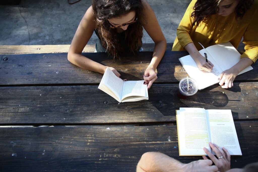 three young women reading together