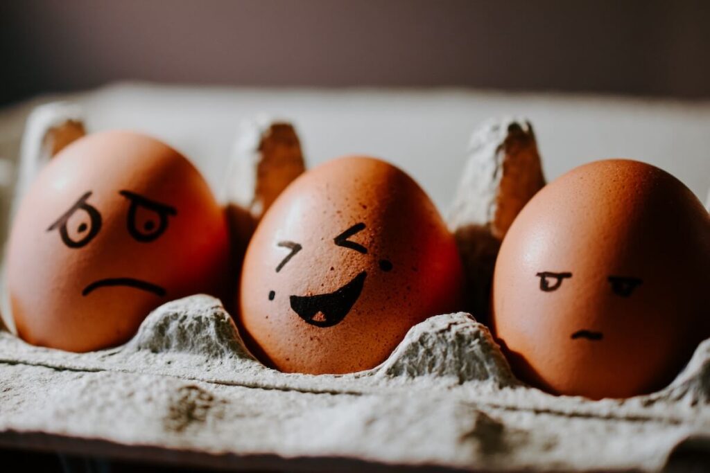 Three brown eggs with drawn faces