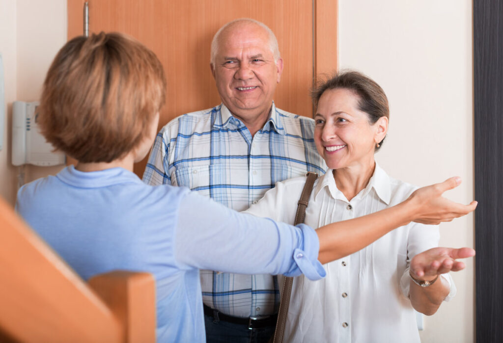 woman greeting guests at door