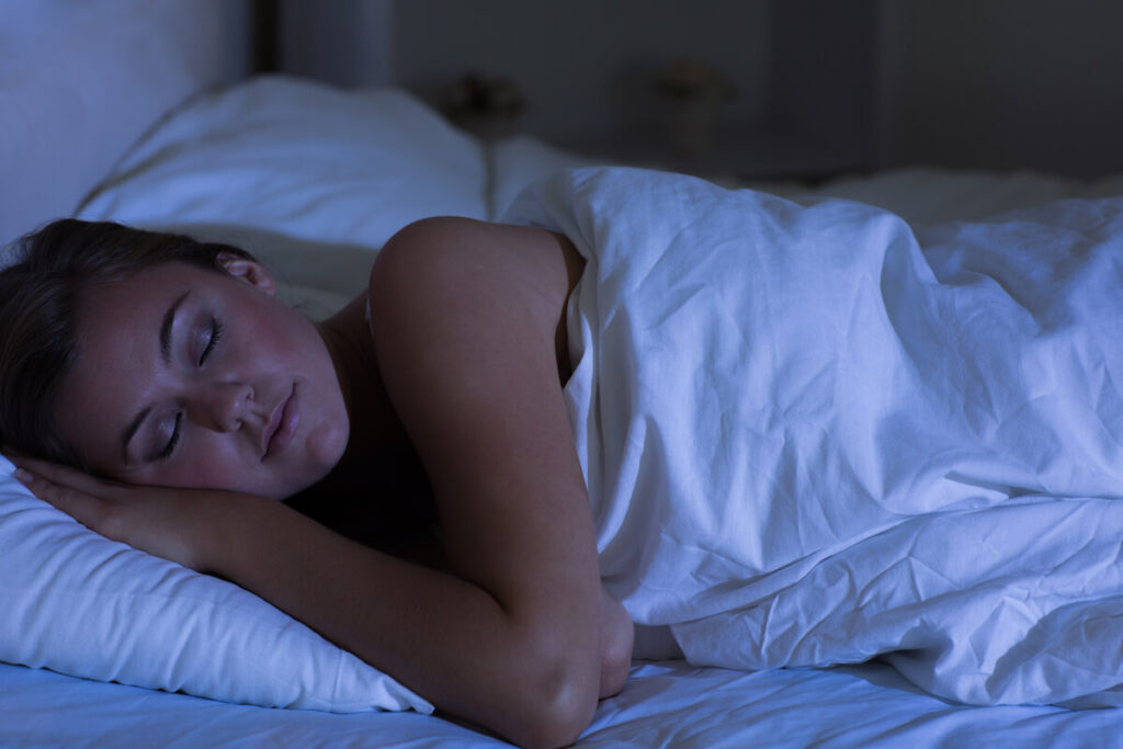 Woman sleeping at night in bedroom