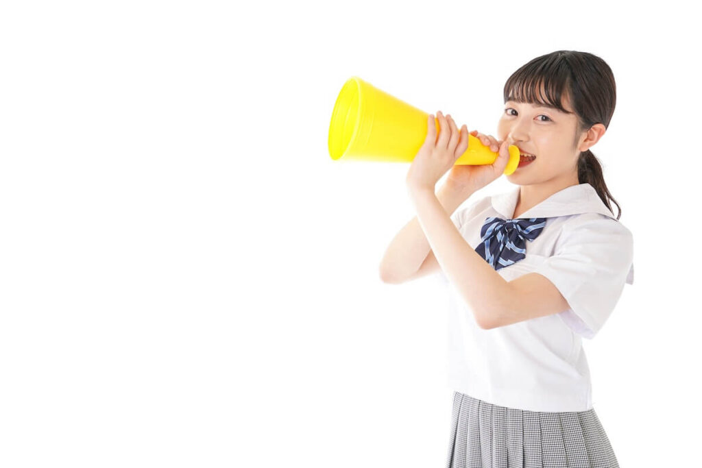 Asian young woman with yellow megaphone isolated on white background