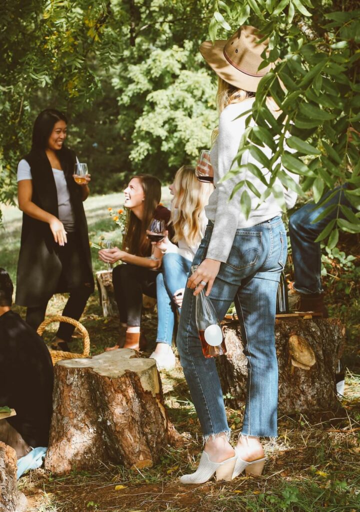 female friends laughing and drinking wine