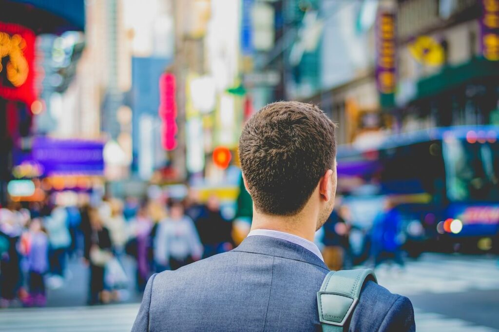 man in suit walking in the city