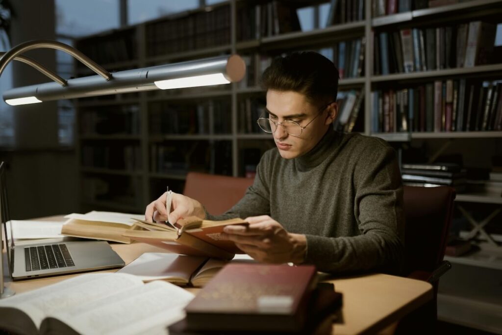 man reading a book in a library