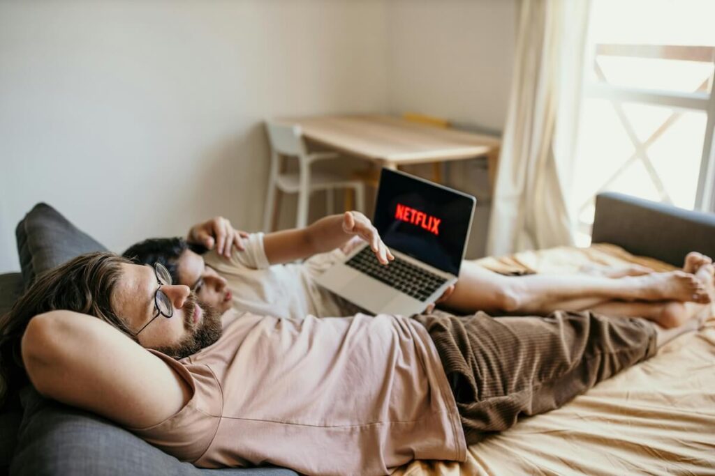 couple watching Netflix in bed