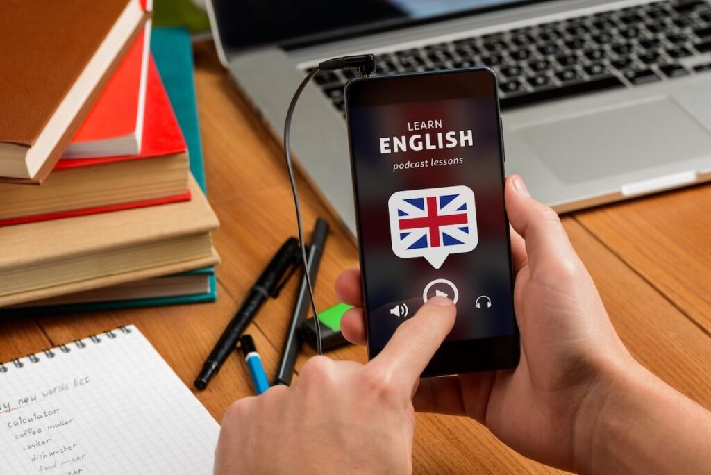hand holding mobile phone showing English podcast lesson