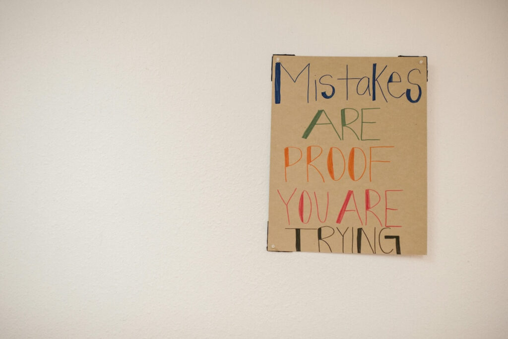 handwritten sign saying "mistakes are proof you are trying"