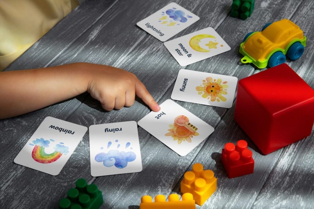 child pointing to a flashcard